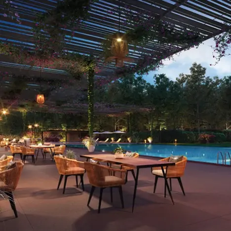 Lodha Mirabelle, near Manyata Tech Park Poolside dining tables under a lit pergola at dusk, Lodha Mirabelle